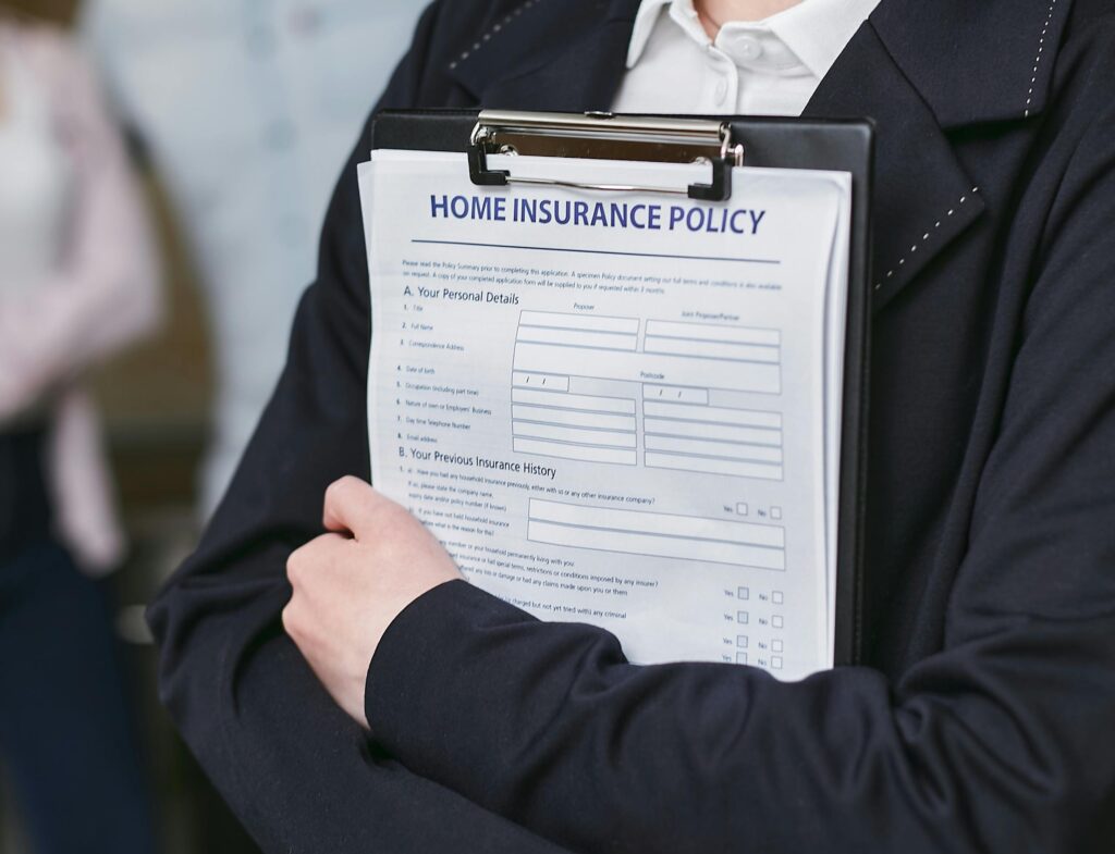 Close-up of a person holding a home insurance policy on a clipboard, captured indoors indicating
seo for insurance companies
