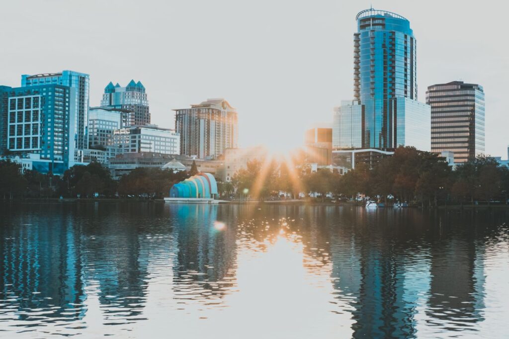 pexels-photo-11665601-11665601 Capture of Orlando's skyline reflecting in a lake during sunrise, showcasing urban beauty and tranquility.
