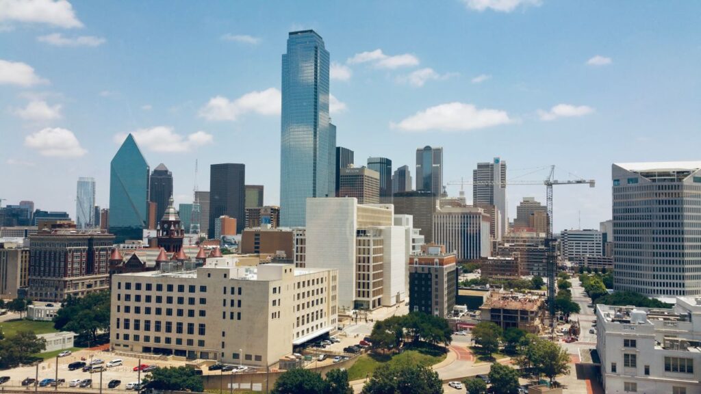 pexels-photo-13250722-13250722 Aerial view of Dallas skyline featuring modern skyscrapers under a clear blue sky.