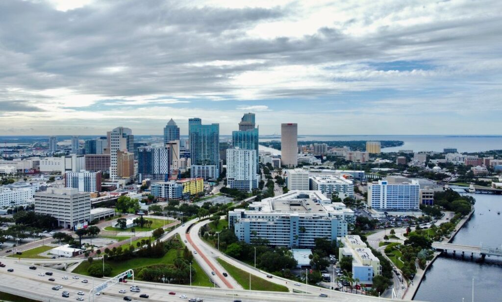 pexels-photo-14724734-14724734 A stunning aerial view of Tampa, FL cityscape featuring modern skyscrapers against clouded skies.