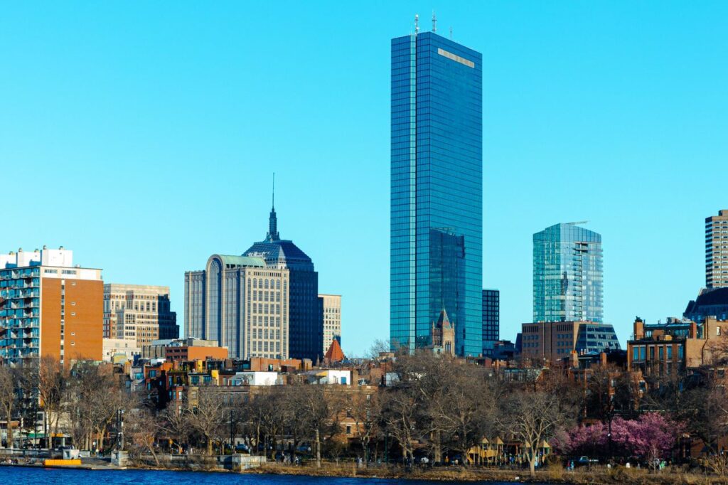 pexels-photo-21314036-21314036 Stunning view of Boston's skyline featuring the iconic John Hancock Tower and modern architecture.