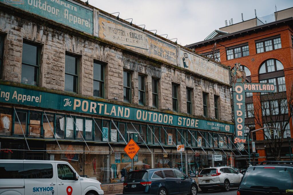pexels-photo-3995715-3995715 Street view of the iconic Portland Outdoor Store with vintage signage and urban scenery.