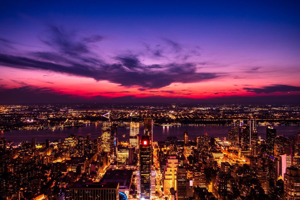 pexels-photo-941459-941459 Stunning aerial view of New York City skyline against a dramatic sunset sky with vibrant lights.